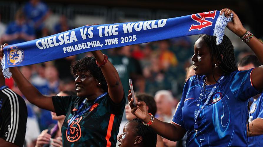 Chelsea fans hold aloft a scarf inside Lincoln Financial Field