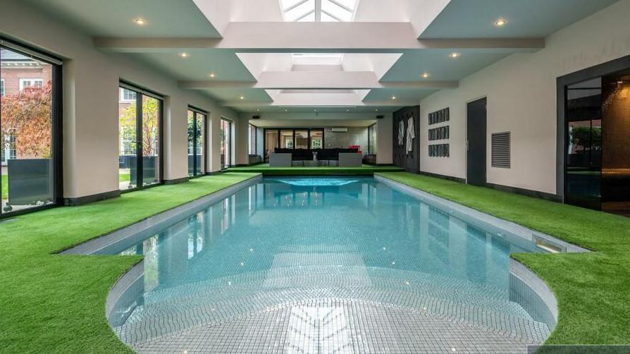 The swimming pool at Klopp's ex home edged with artificial grass