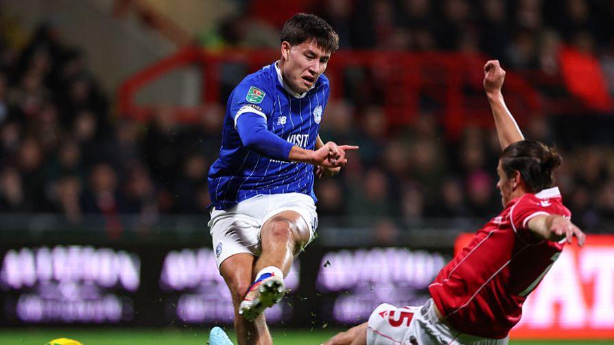 Cardiff City's Rubin Colwill (L) shoots