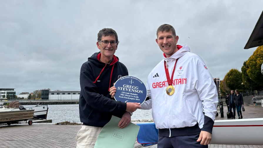 Club captain gives Gregg and blue plaque to honour him