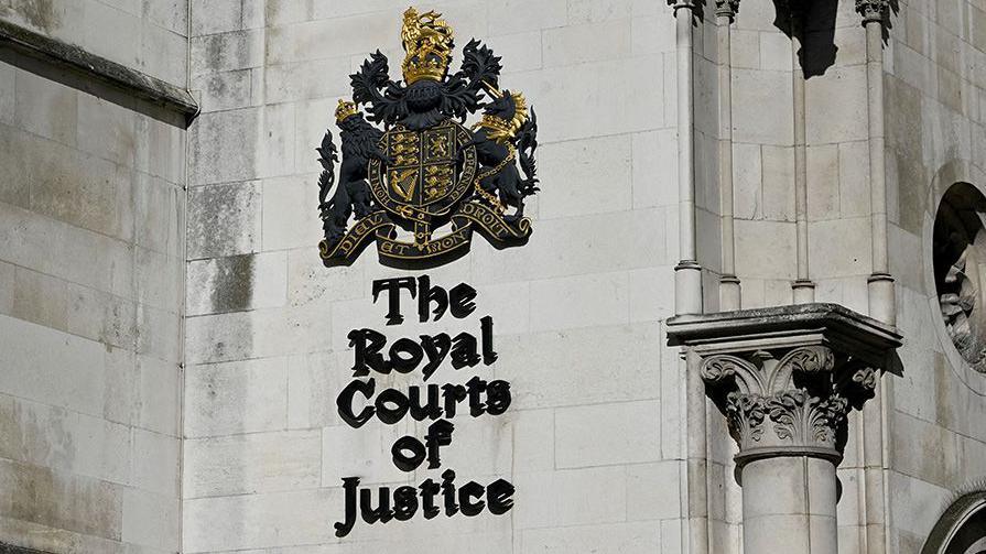 General view shows a signage at the High Court in London