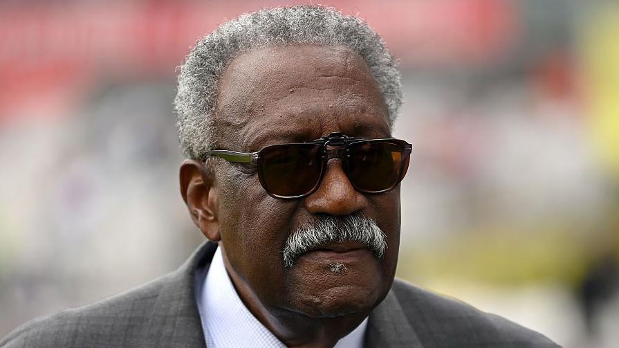 Sir Clive Lloyd, wearing a suit and sunglasses