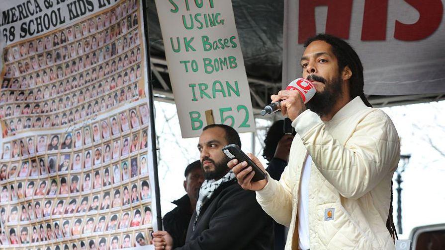 Rapper Bobby Vylan addresses the gathered crowd during the demonstration on 15 March
