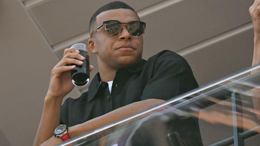 Kylian Mbappe stands on the balcony in the pit lane of the Circuit de Monaco for an F1 race