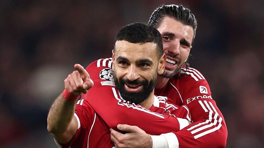 Mohamed Salah points as he is hugged by Liverpool team-mate Dominik Szoboszlai