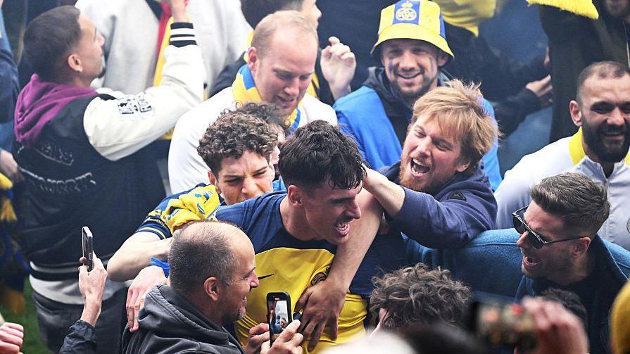 Ross Sykes celebrates with Union supporters after they won the title last season