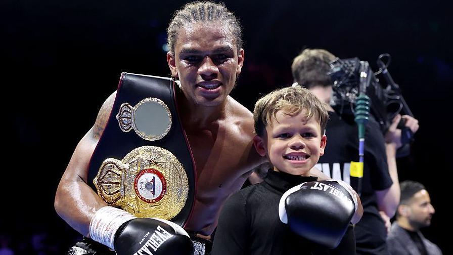 Gerome Warburton celebrates his win with son Roman