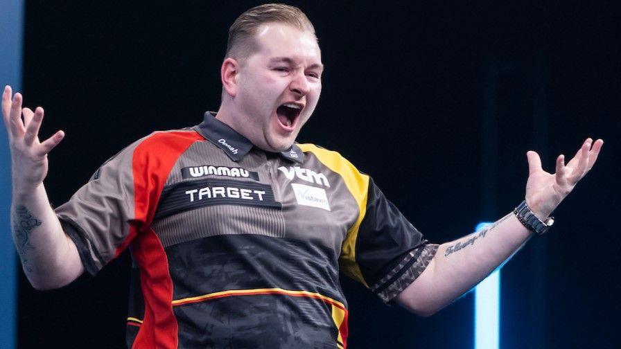 Dimitri van den Bergh celebrates beating Michael van Gerwen