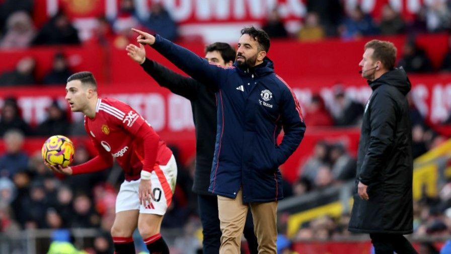 Manchester United head coach Ruben Amorim (front) and Bournemouth manager Andoni Iraola point the way as Diogo Dalot prepares to take a throw at Old Trafford