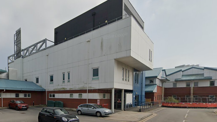 An exterior shot of Liverpool Women's Hospital, with the car park in the foreground 