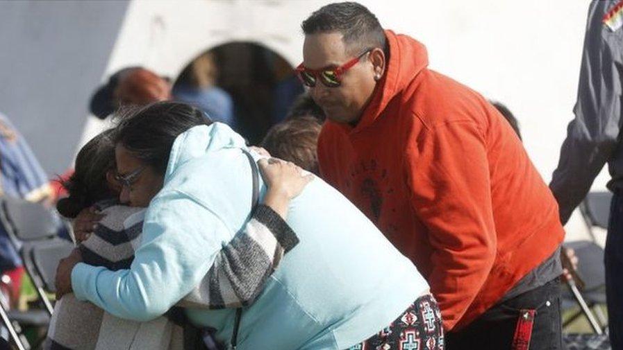 People hug before a a press conference about the stabbings, at James Smith Cree Nation on 8 September