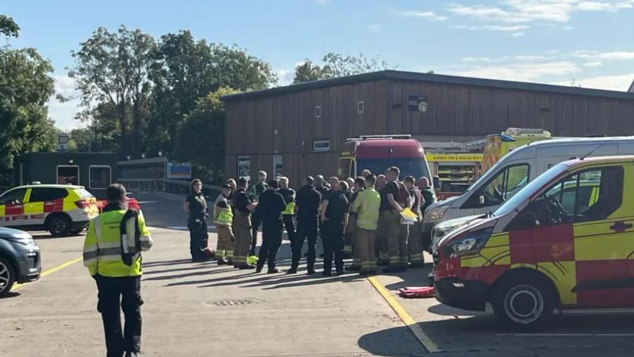 Rescue teams gather by their vehicles in Sunbury