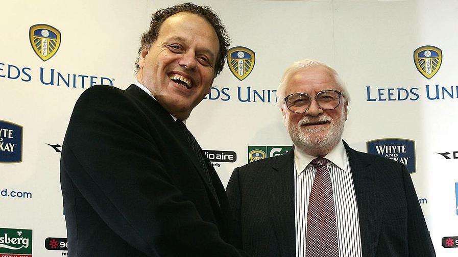 Chairman Ken Bates (right) of Leeds United shakes hand with outgoing chairman Gerald Krasner during a press conference at Elland Road Stadium in January 2005