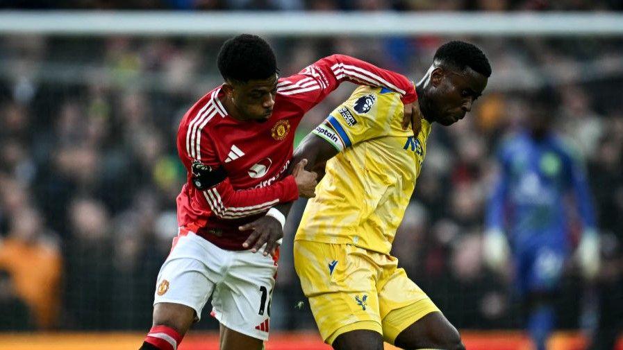 Manchester United's Amad Diallo battles for possession with Crystal Palace skipper Marc Guehi at Old Trafford