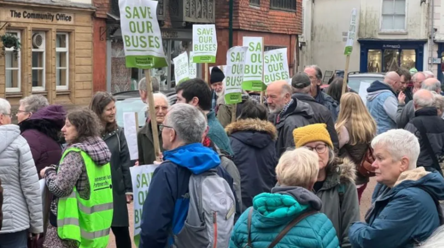 Protesters in a town centre holding placards