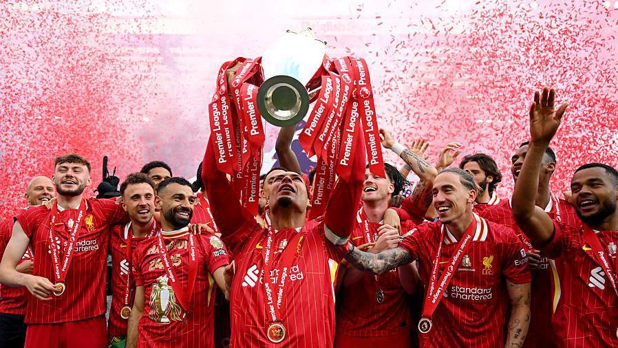 Liverpool captain Virgil van Dijk lifts the Premier League trophy after the game against Crystal Palace at Anfield