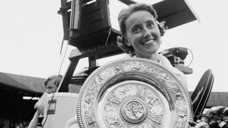 A smiling Angela Mortimer, as she was known then, holds the Venus Rosewater Dish after her victory in the all-British 1961 Wimbledon final