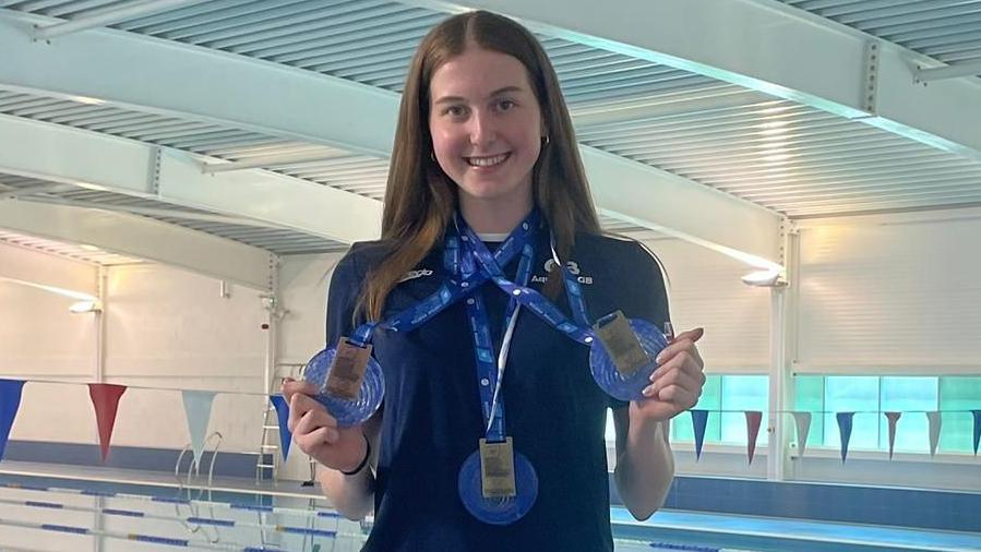 Blythe Kinsman holds her three medals from the European Junior Championships