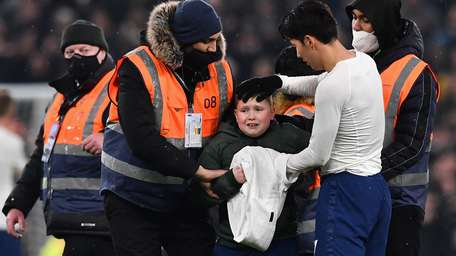 Tottenham forward Son Heung-min gives his shirt to a young fan after the League Cup quarter-final match against West Ham United in December 2021