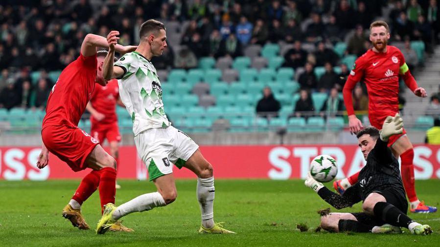 Raul Florucz sees his shot saved by outstretched Larne keeper Rohan Ferguson