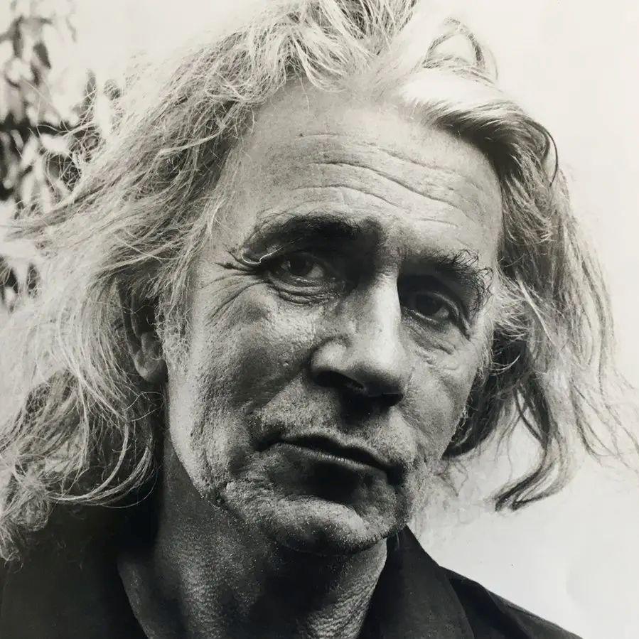 Artist Jamie Reid, a black and white image of him looking at the camera.