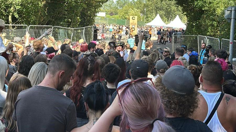 Queues of people waiting outside the gate