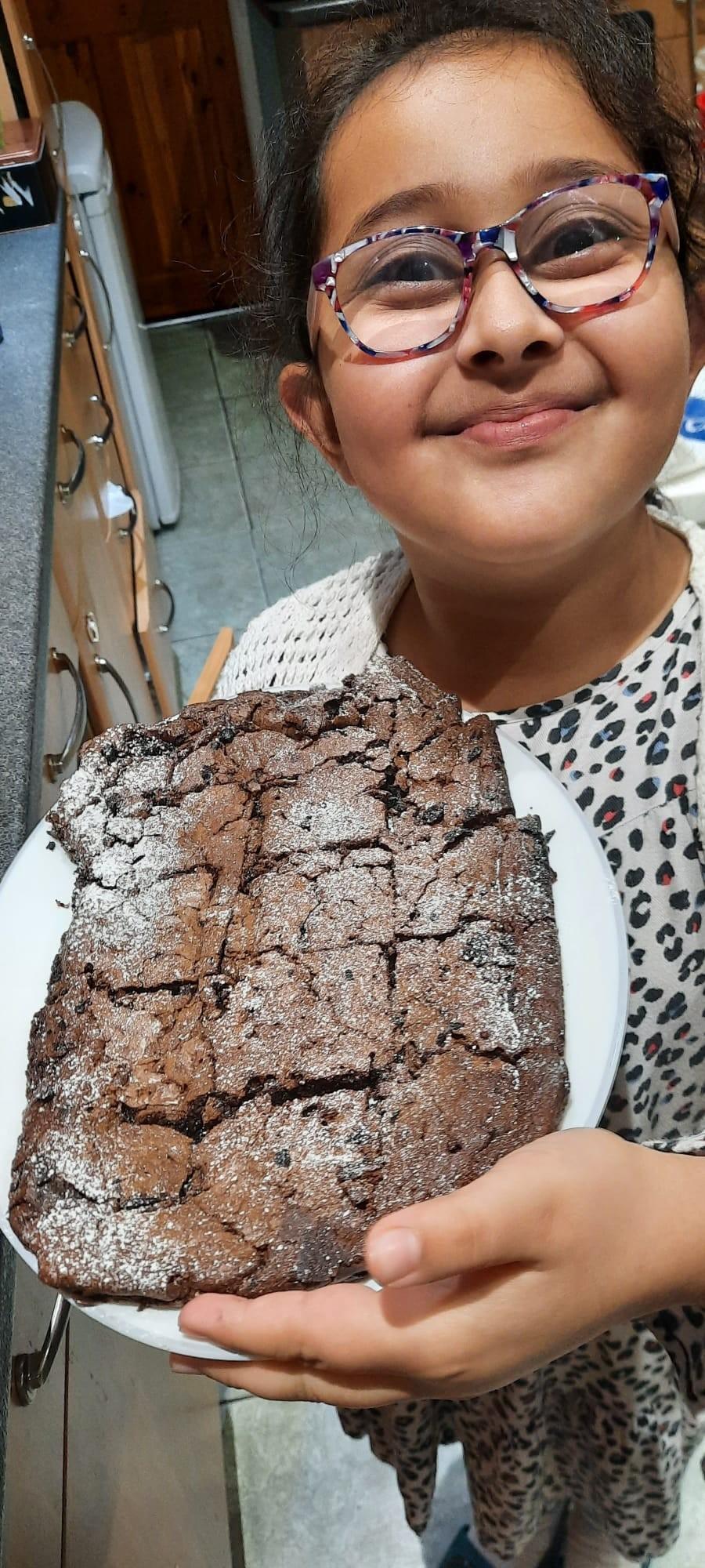 Girl holding tray of brownies.