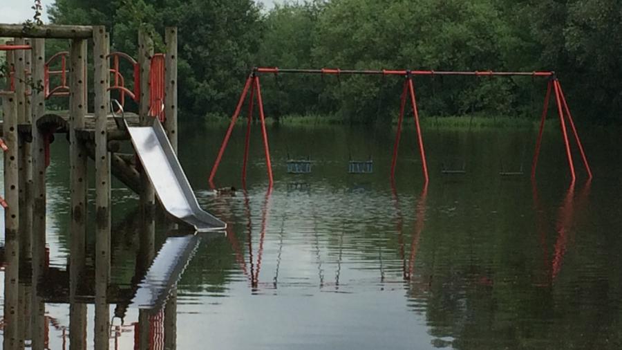 Flooded children's play area near The Meadows in Stafford