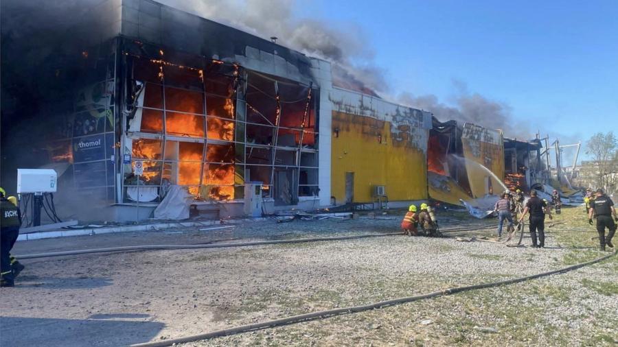 Rescuers work at a site of a shopping mall hit by a Russian missile strike, as Russia's attack on Ukraine continues, in Kremenchuk, in Poltava region, Ukraine 27 June 2022