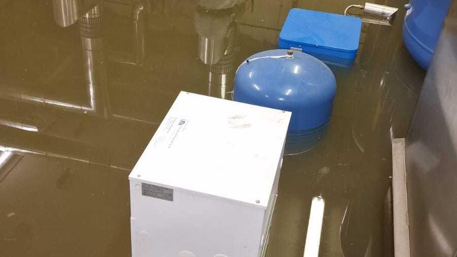 Electrical equipment partially submerged in flood water in a basement