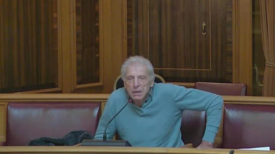Cruxton farmer Anthony Warren speaking at the meeting at Dorset Council. He is behind a microphone.