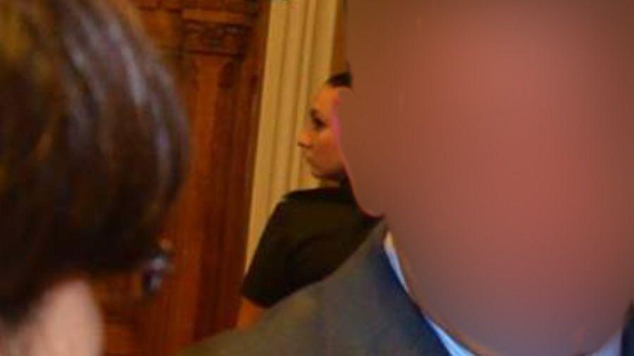 Katrin Ivanova (centre), behind a man whose face is blurred