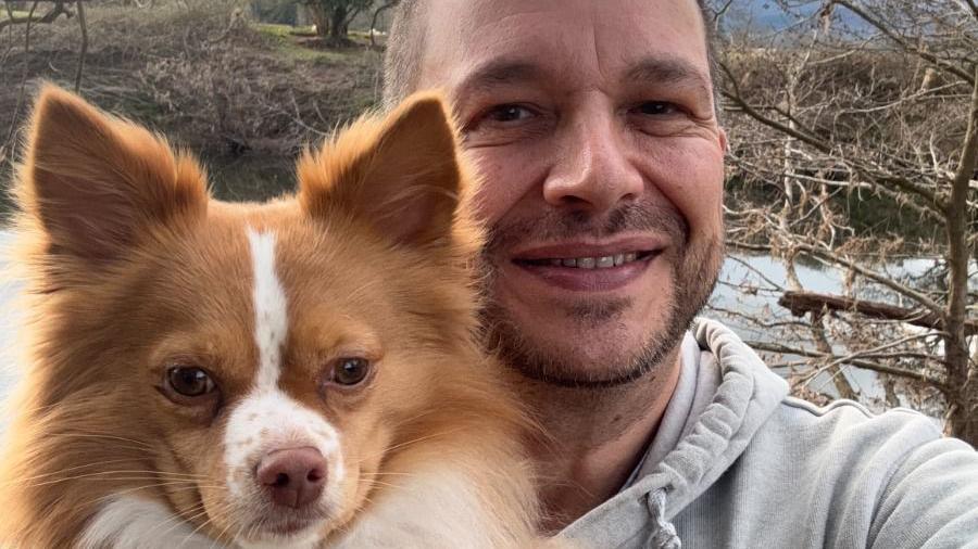 Gino Parisi and his dog pictured alongside the river Usk.  