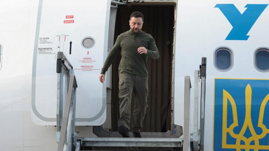 Zelensky, wearing khaki trousers and a long-sleeve top, disembarks a plane in Ireland - on his way to DC