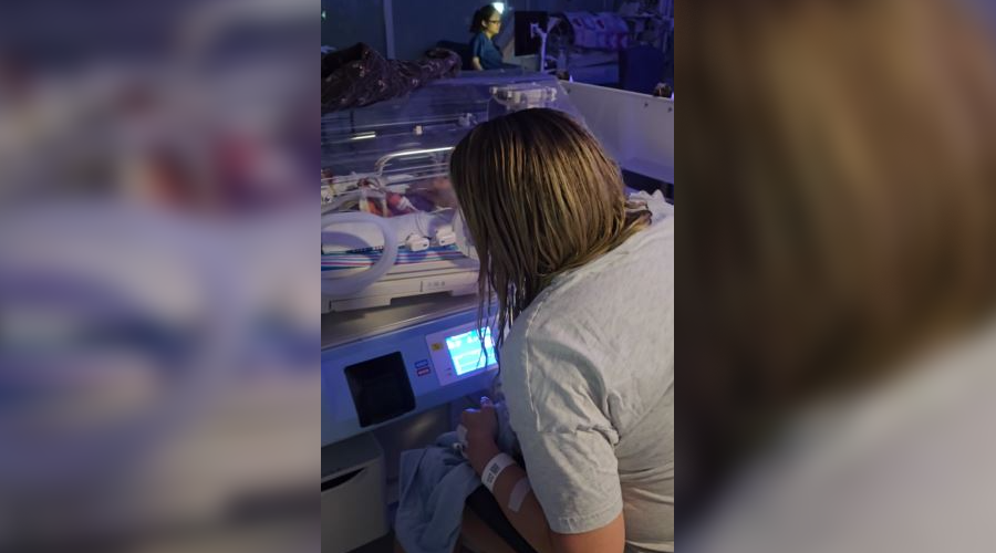 The actress greets Benji in the specialist NICU cot