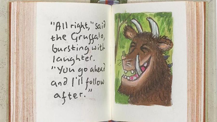 A tiny version of the children's book is shown