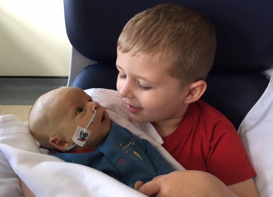 A "magical moment" for Charlie, 5, holding his baby brother Max who had been in the neonatal intensive care unit for 40 days