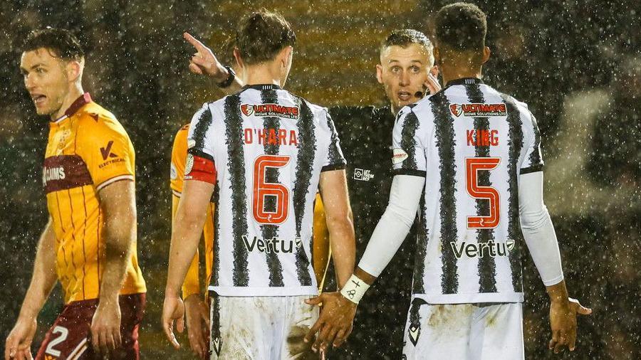 St Mirren's Richard King (R) remonstrates with Referee Calum Scott (C) after being shown a red card during a William Hill Premiership match between St Mirren and Motherwell at the SMiSA Stadium