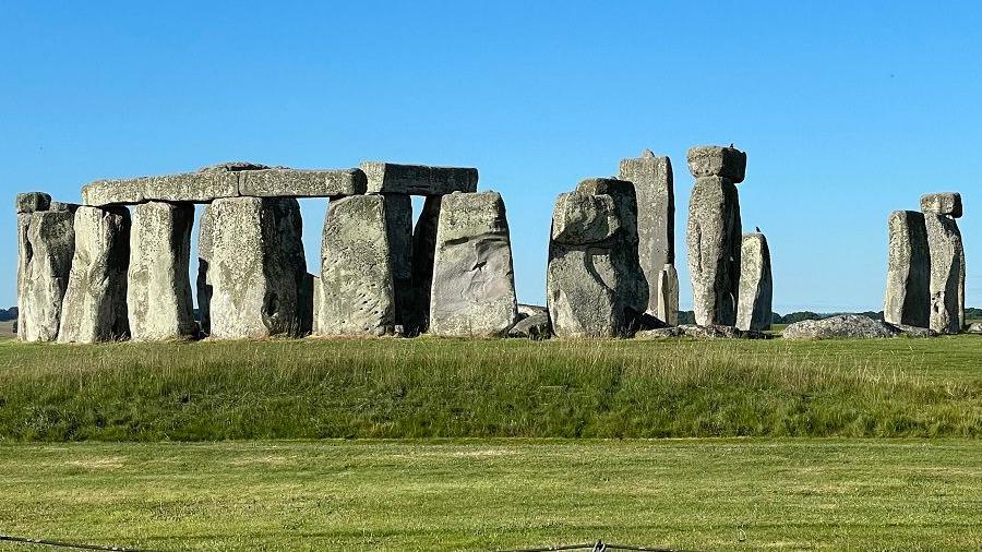 Stonehenge with grass surround under a blue sky