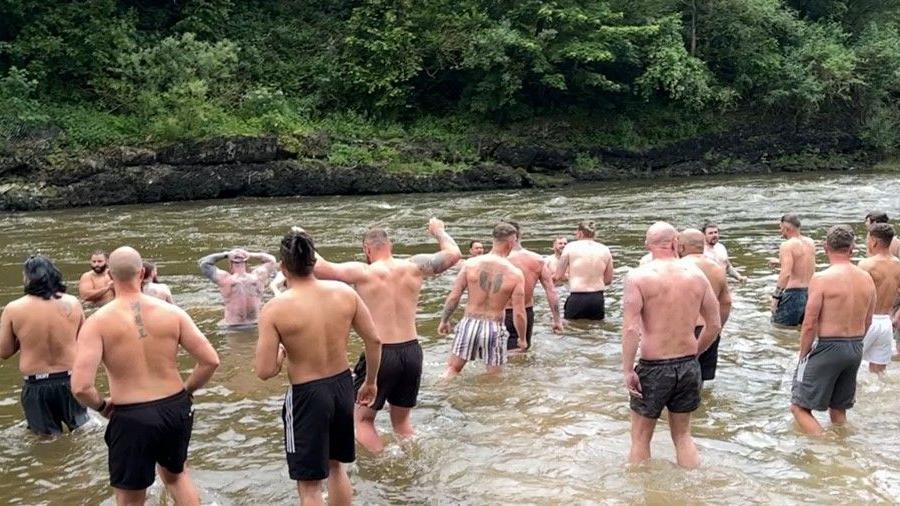 A group of men taking a dip in the River Severn