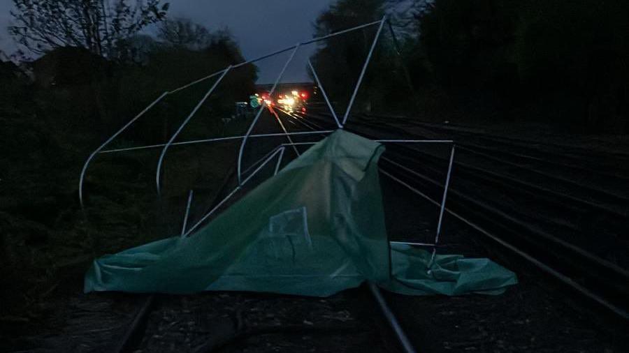 A greenhouse on train tracks.