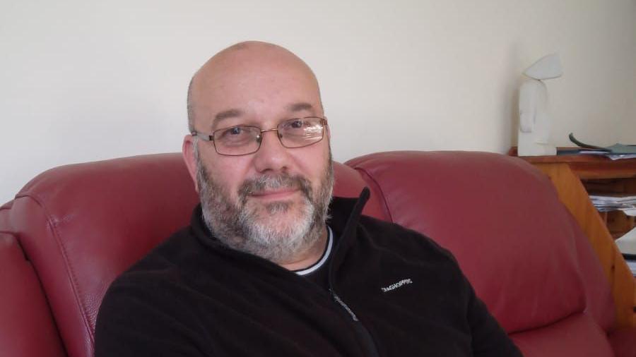 Toby McKenzie is representing the Reform Party in South West Norfolk pictured sitting in a red chair