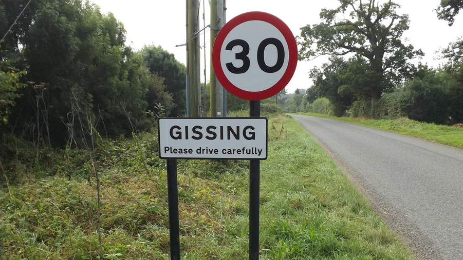 Village road sign for Gissing with 30mph 