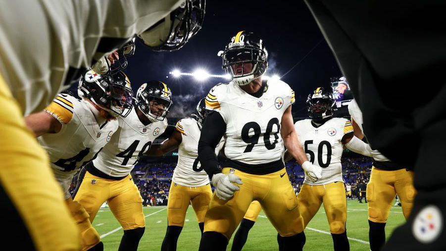 The Pittsburgh Steelers players in a huddle before playing Baltimore