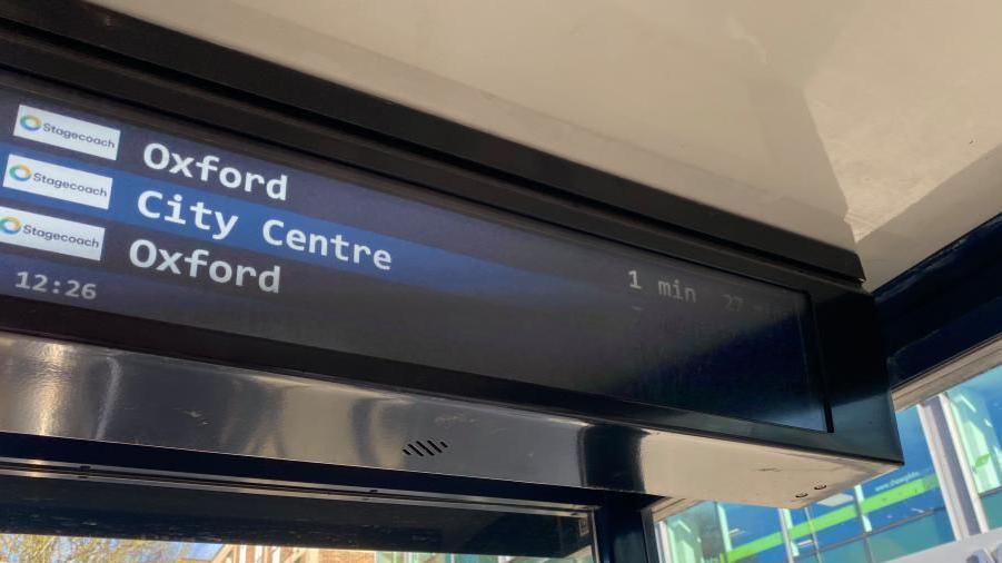 A digital display board showing the times the next buses are due