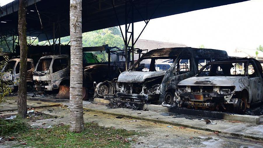 Charred vehicles are seen at the Bongor Subdistrict Administrative Organisation office in Ra-ngae district in the southern Thai province of Narathiwat