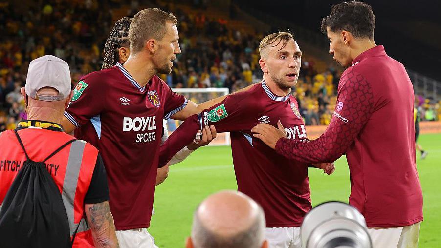 Jarrod Bowen of West Ham United is pulled away after clashing with West Ham supporters