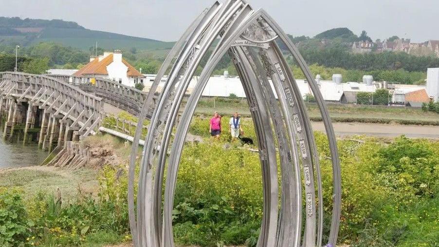 The Old Shoreham Toll Bridge memorial. The silver structure is beside the bridge. 