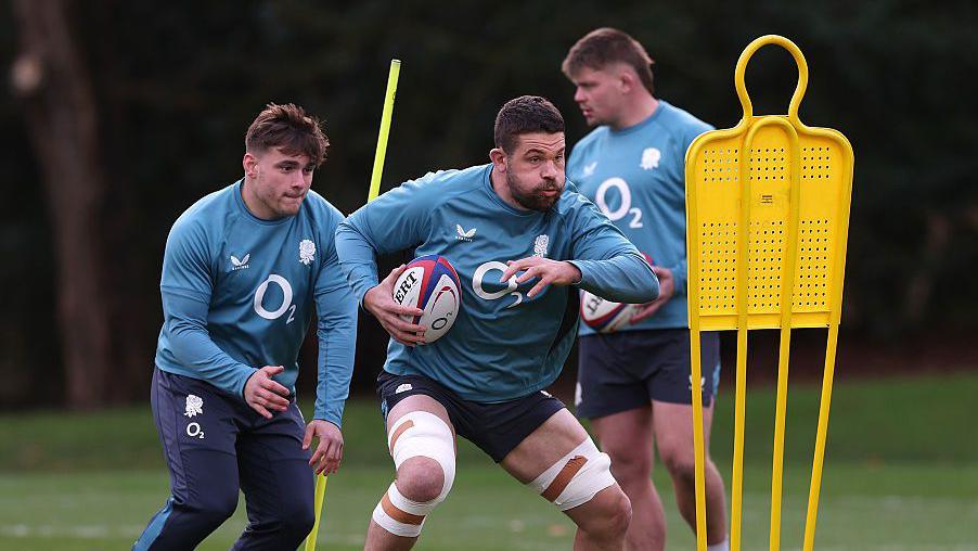 Charlie Ewels with the ball in his right hand during an England training session