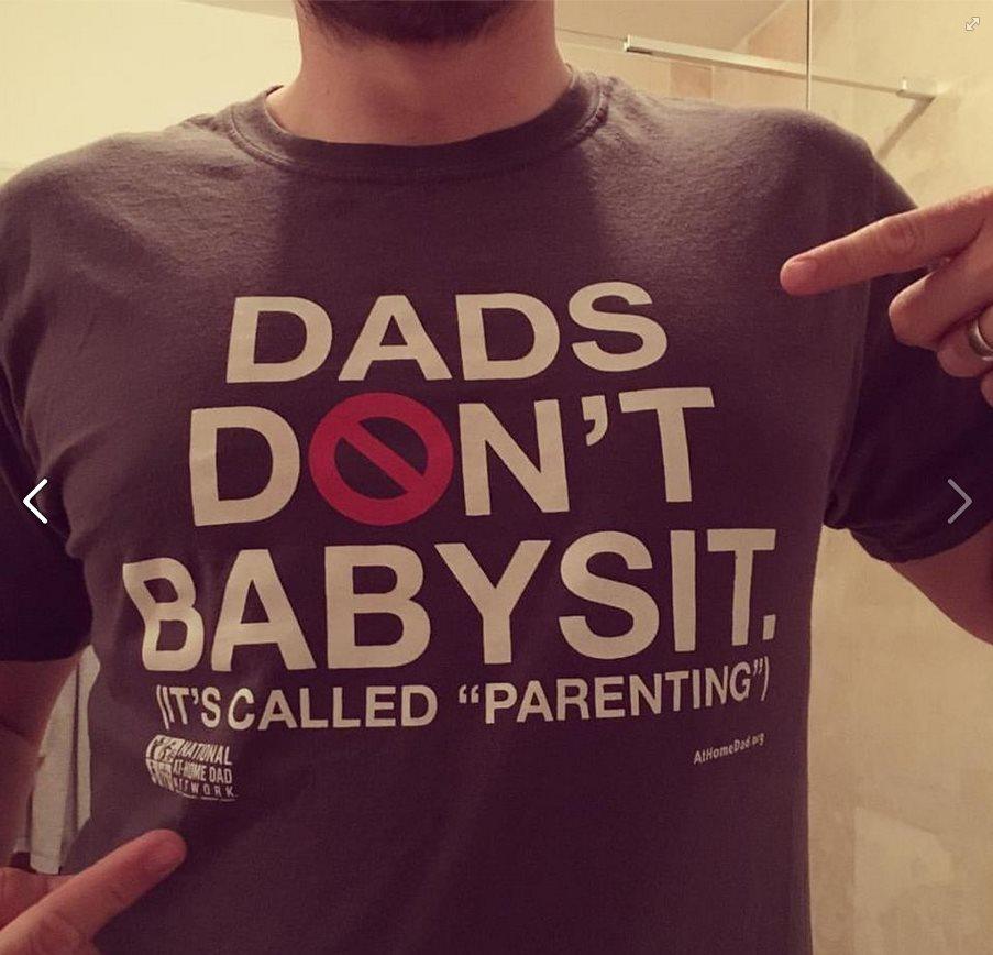 Man in t-shirt which bears a slogan: "Dads don't babysit. It's called parenting."